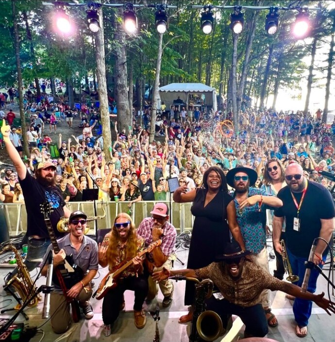 Debrissa and band onstage before a festival crowd